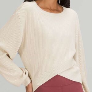 Women's Lululemon Reversible Crossover Sweater in tan. Model shown is in cream.